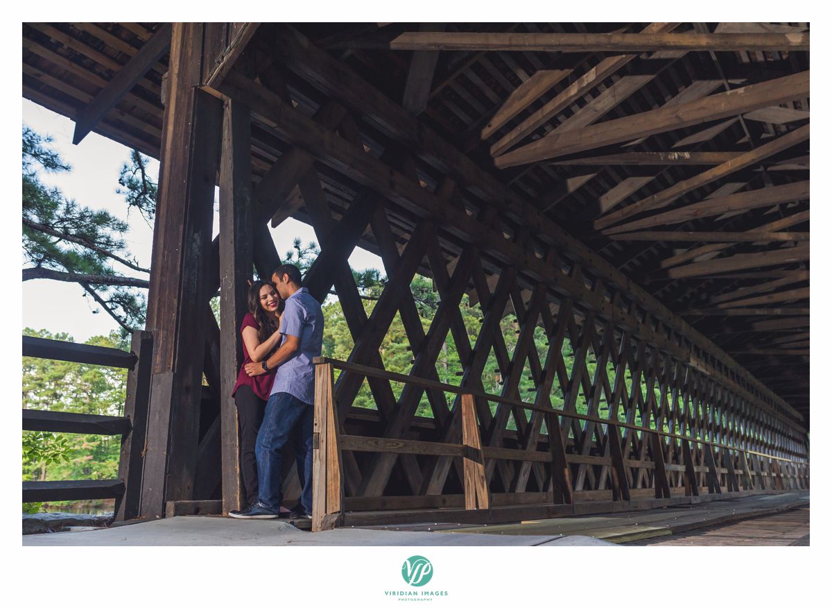 couple under covered bridge in stone mountain park
