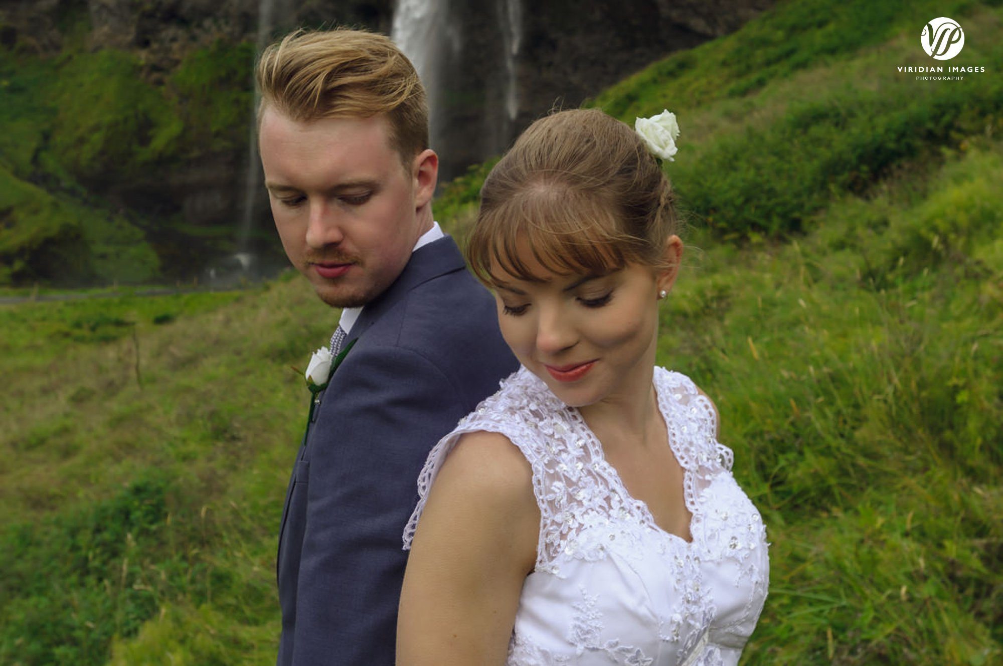 Loving moment of couple at Seljalandsfoss waterfall Iceland