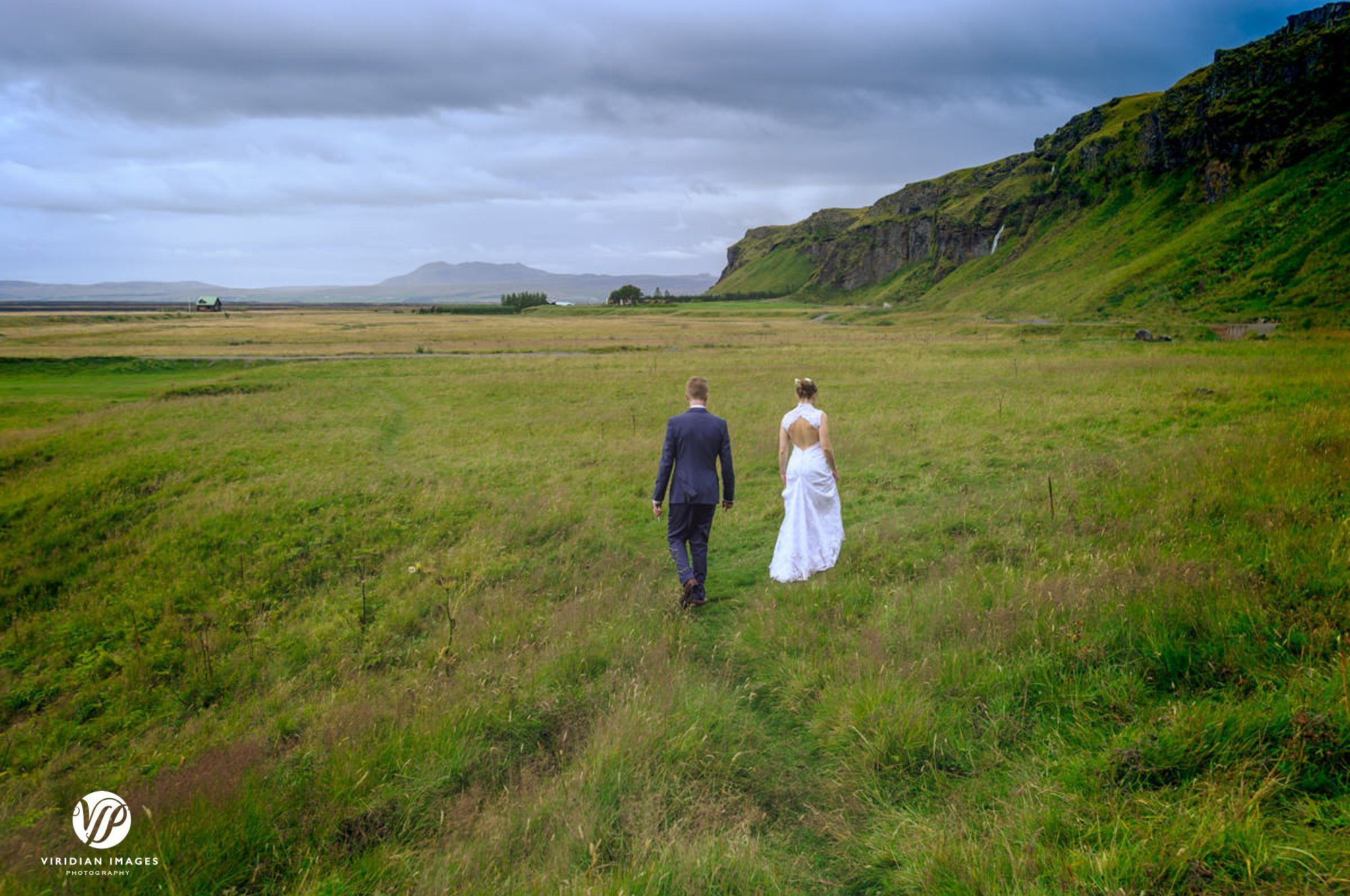 Couple walk down from Seljalandsfoss