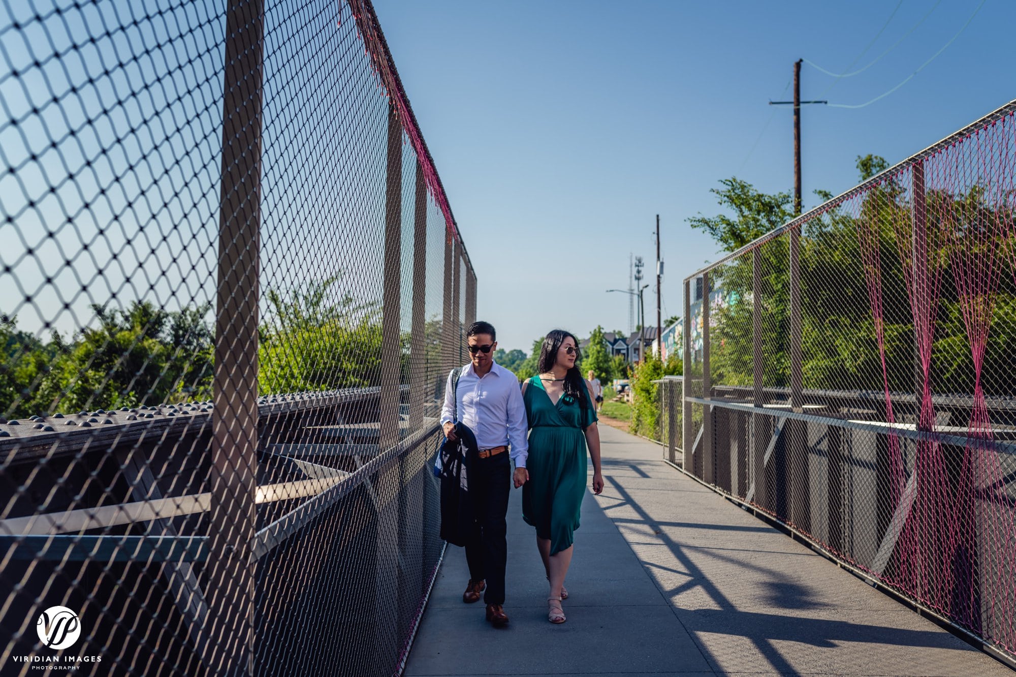 couple walking on beltline bridge sunglasses