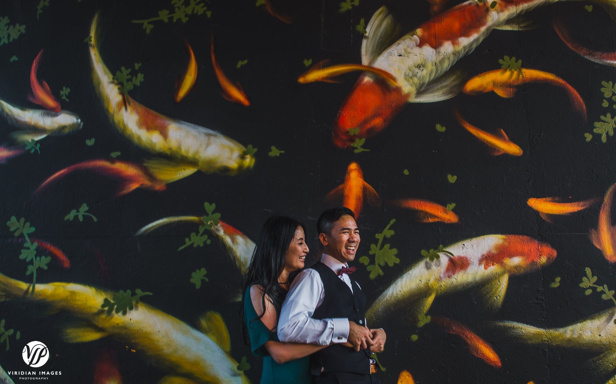 playful couple tickling fish mural atlanta beltline