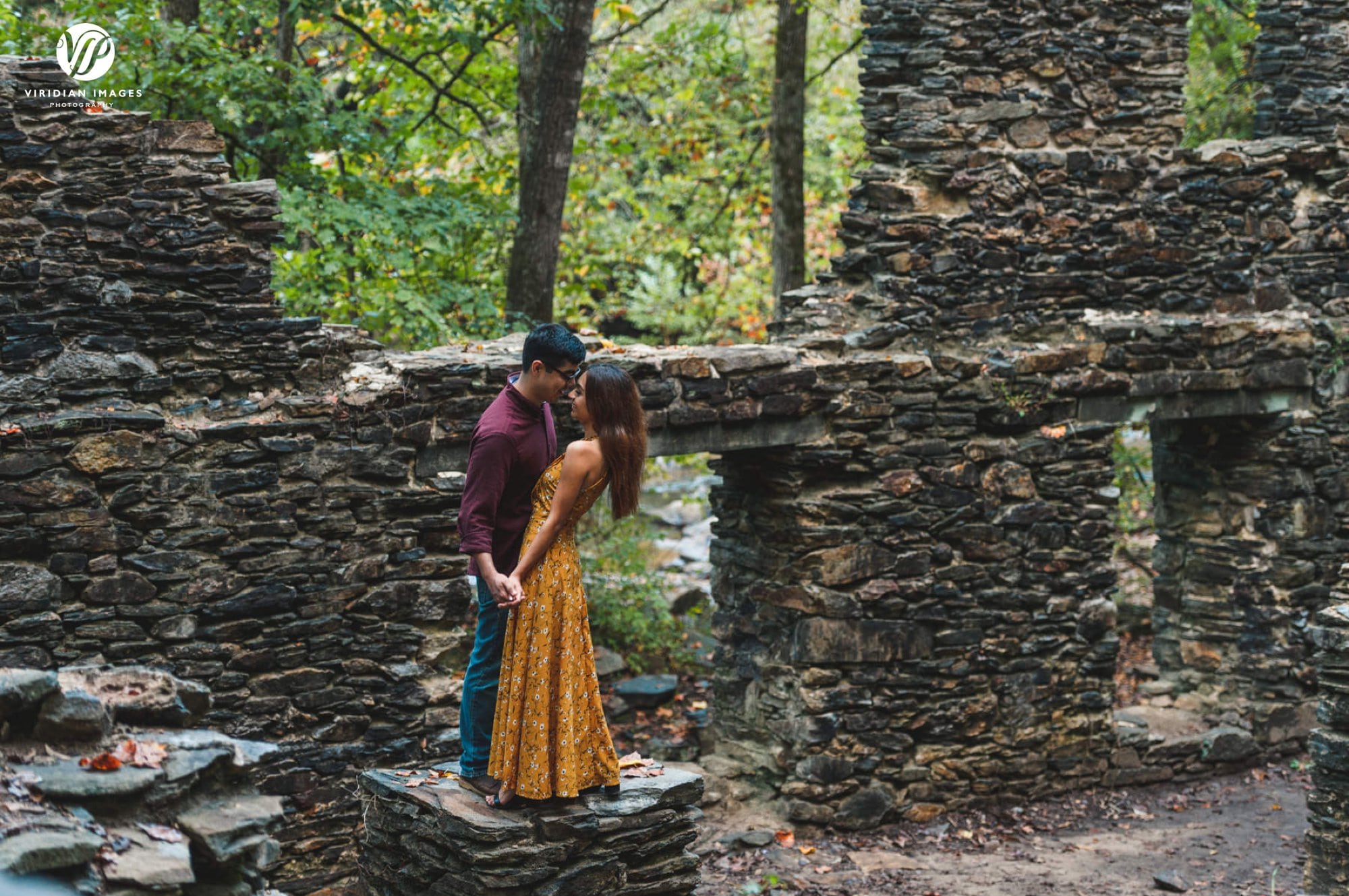 Couple embrace in old mill ruins