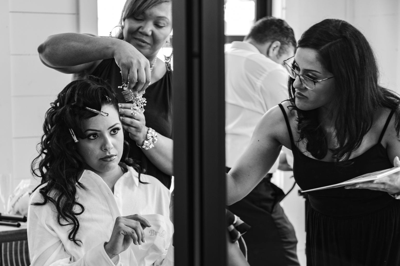 bride getting ready with team bw