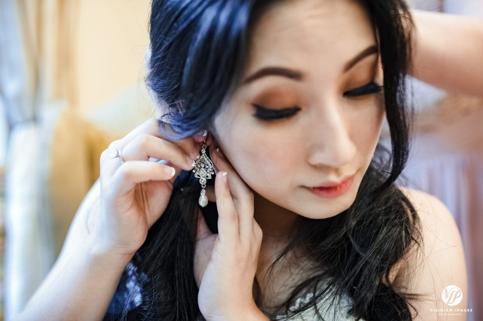 bride putting on earing