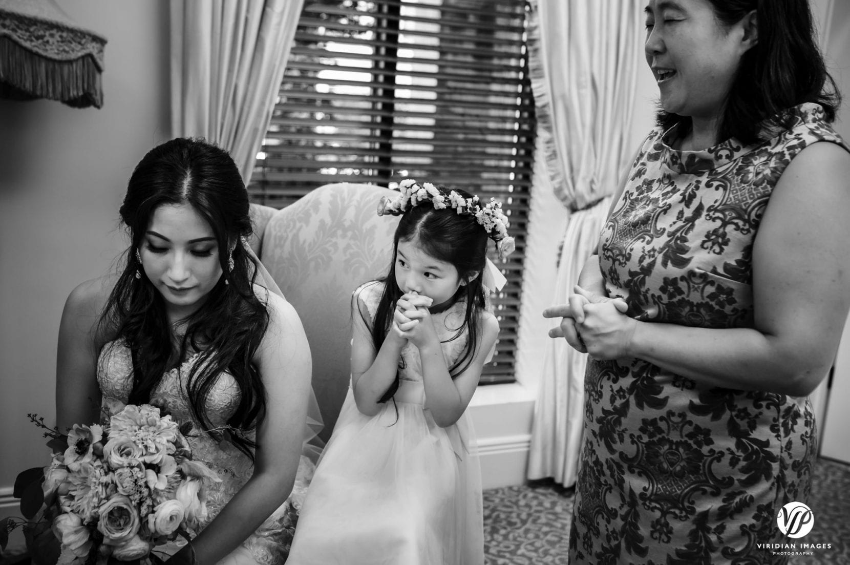 bride and flower girl with paster praying