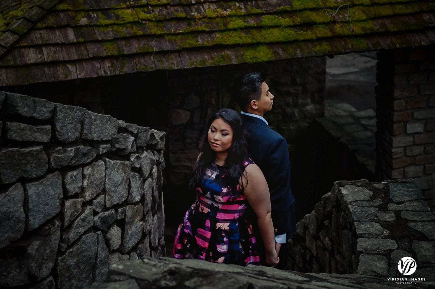couple back to back on stone stairs in stone mountain park atlanta engagement photo