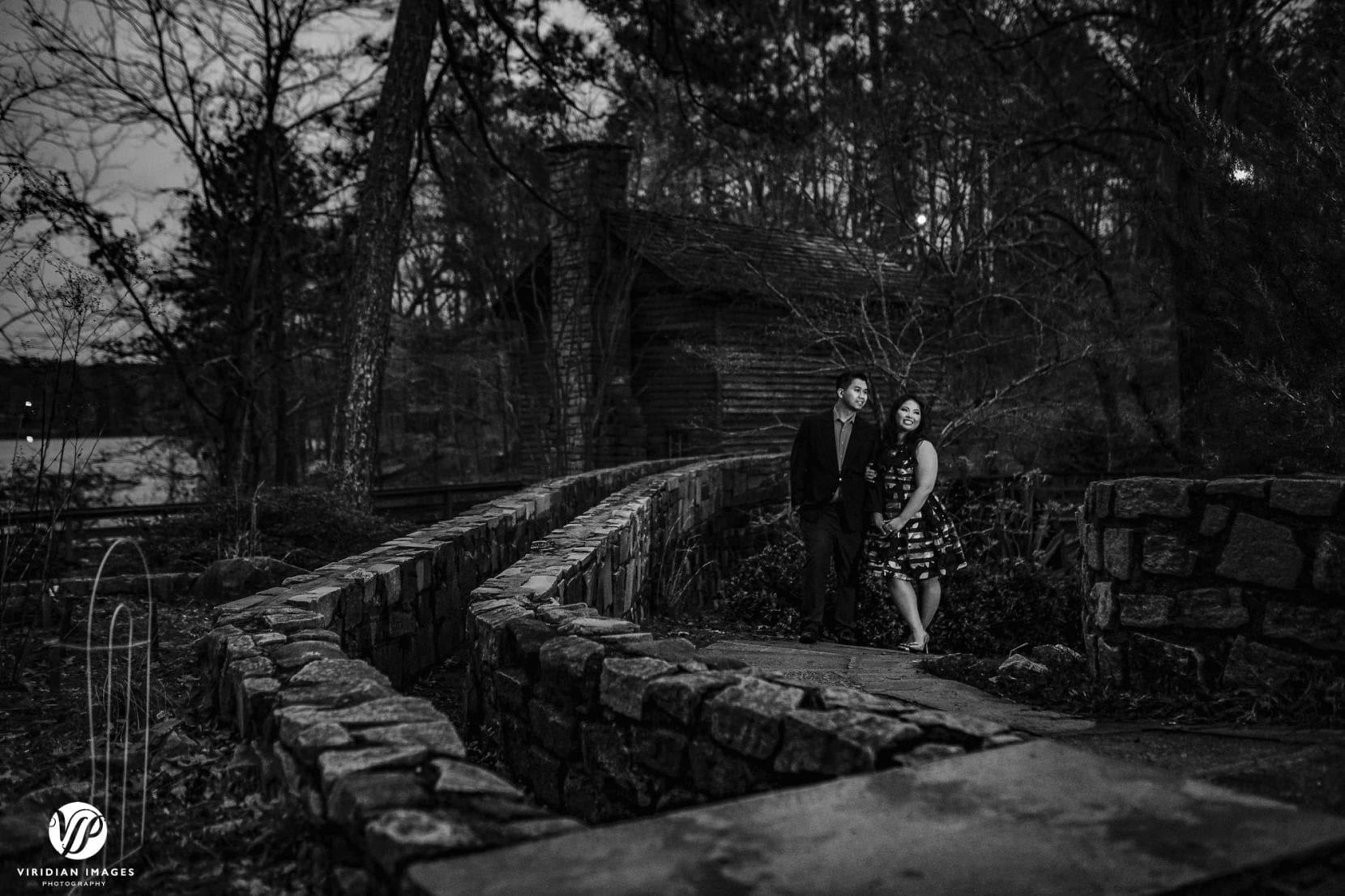 couple walking along stone path atlanta stone mountain park engagement photo