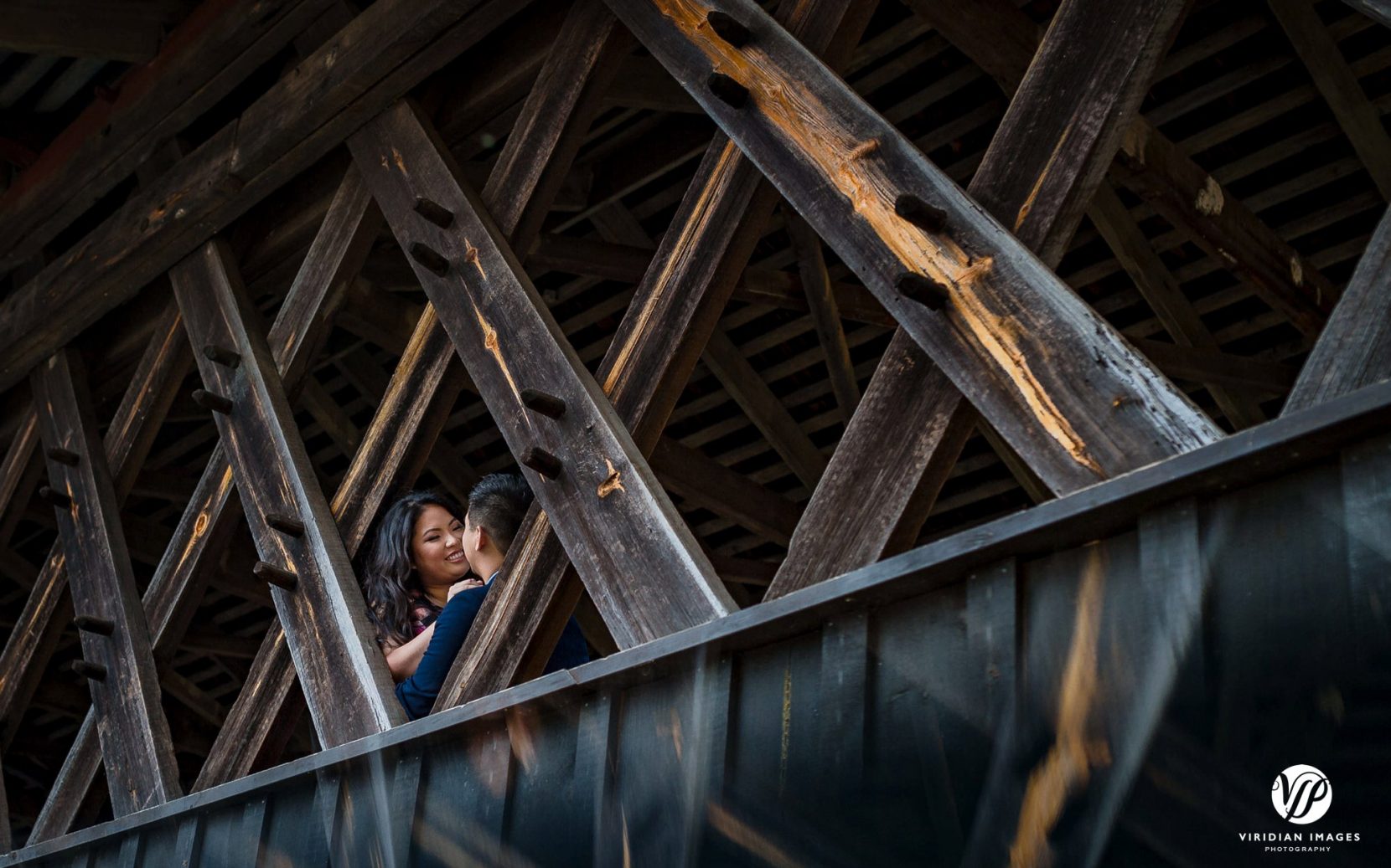 romantic couple face to face covered bridge in atlanta stone mountain park engagement photo