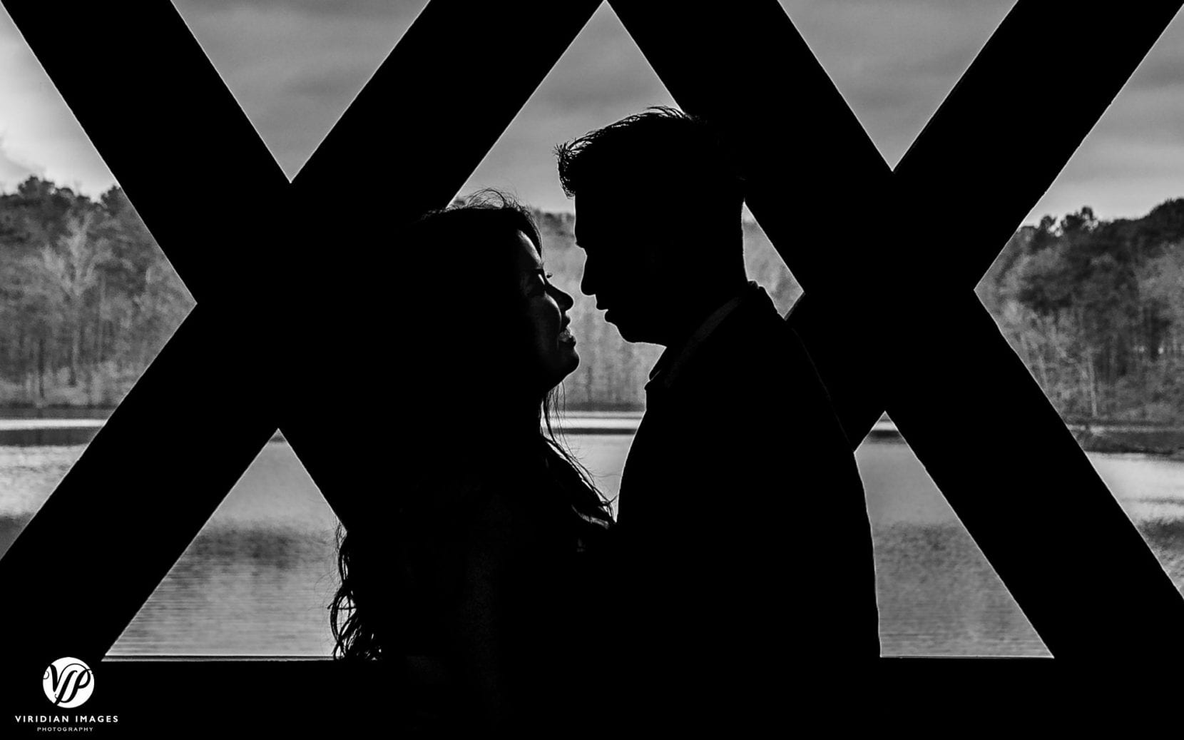 silhouette black and white couple looking at each other covered bridge in atlanta stone mountain park engagement photo
