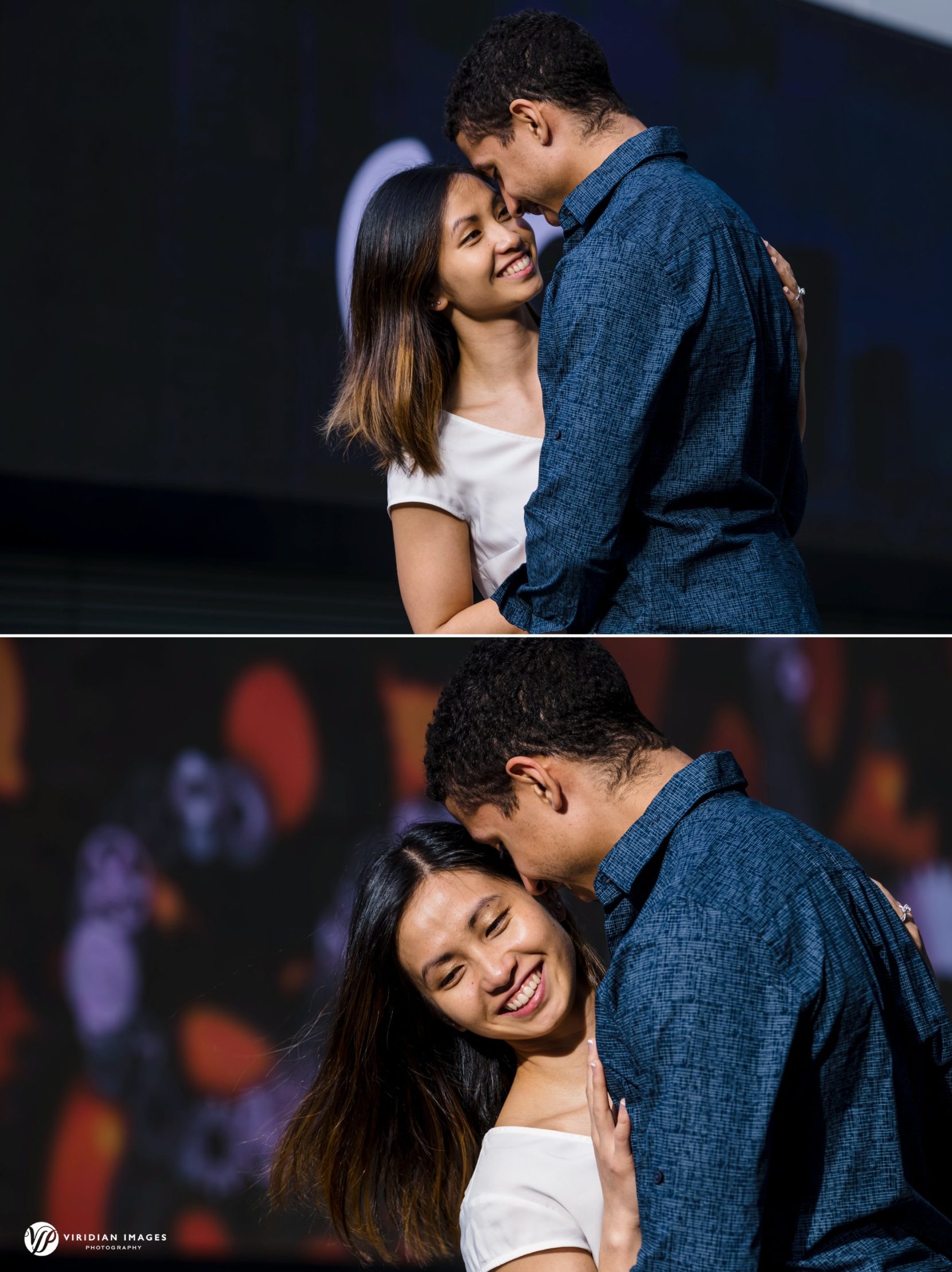 Engaged couple hug in front of large video screens at Georgia's Tech Square campus