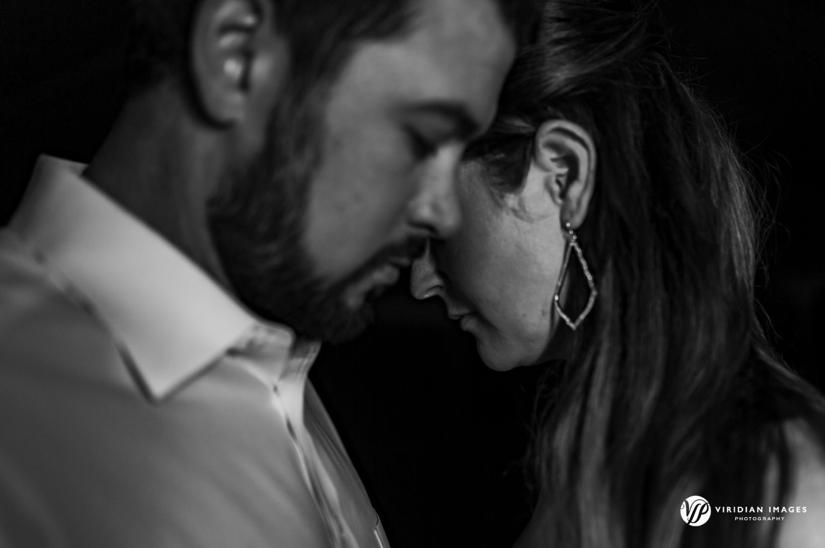 editorial style photo of couple staggered in pose in black and white