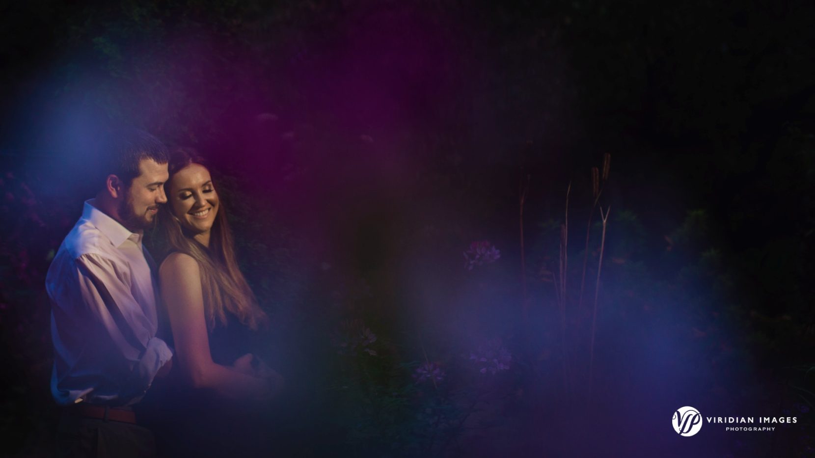 soft photo of engaged couple laughing during engagement session in Atlanta