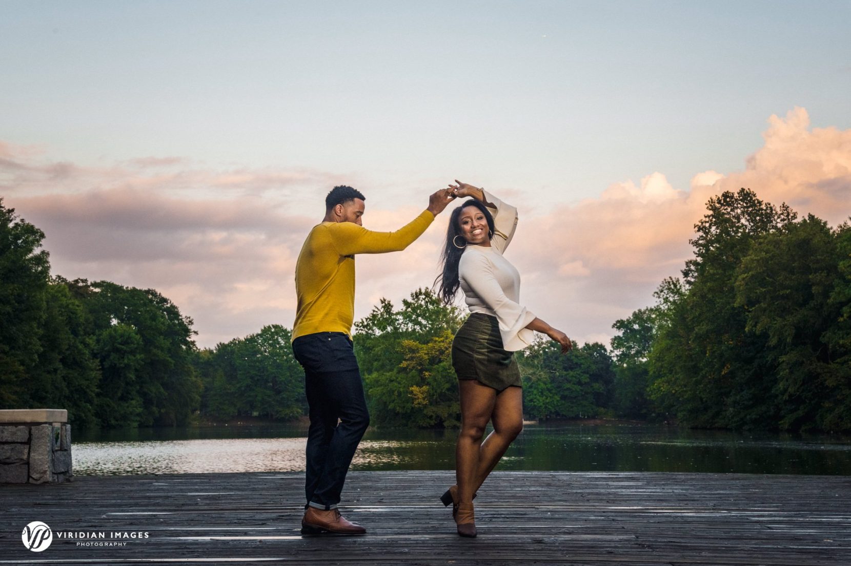 couple dancing on wood dock at piedmont park