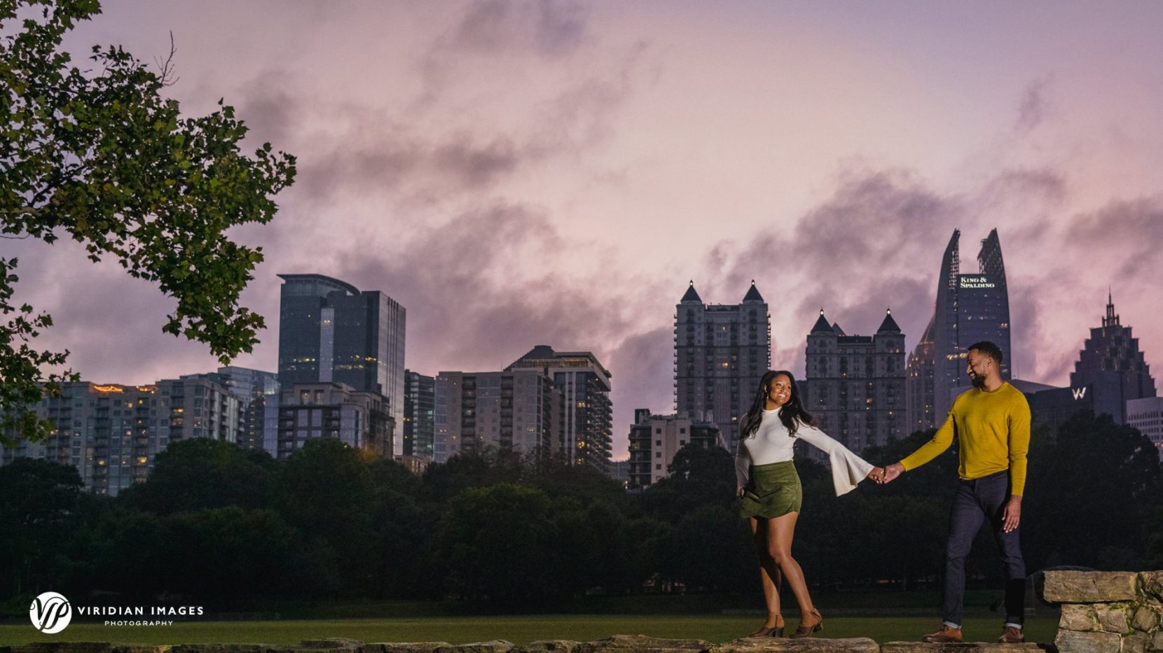 couple walking against city skyline during sunset in atlanta