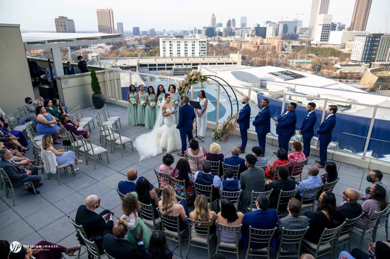 Guests watching wedding ceremony taken from top at Ventanas Atlanta