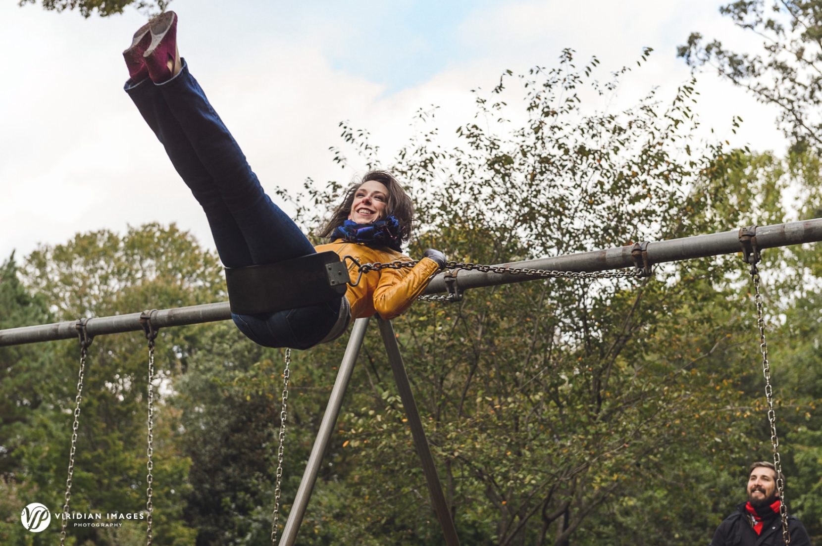 Playful moment of the bride to be swinging at Grant Park in Atlanta.