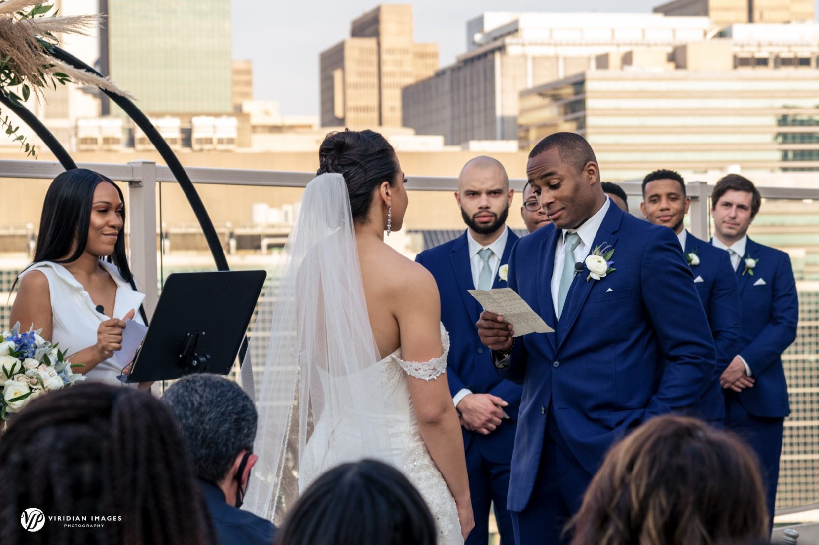 wedding ceremony reading vows against Atlanta city skyline backdrop