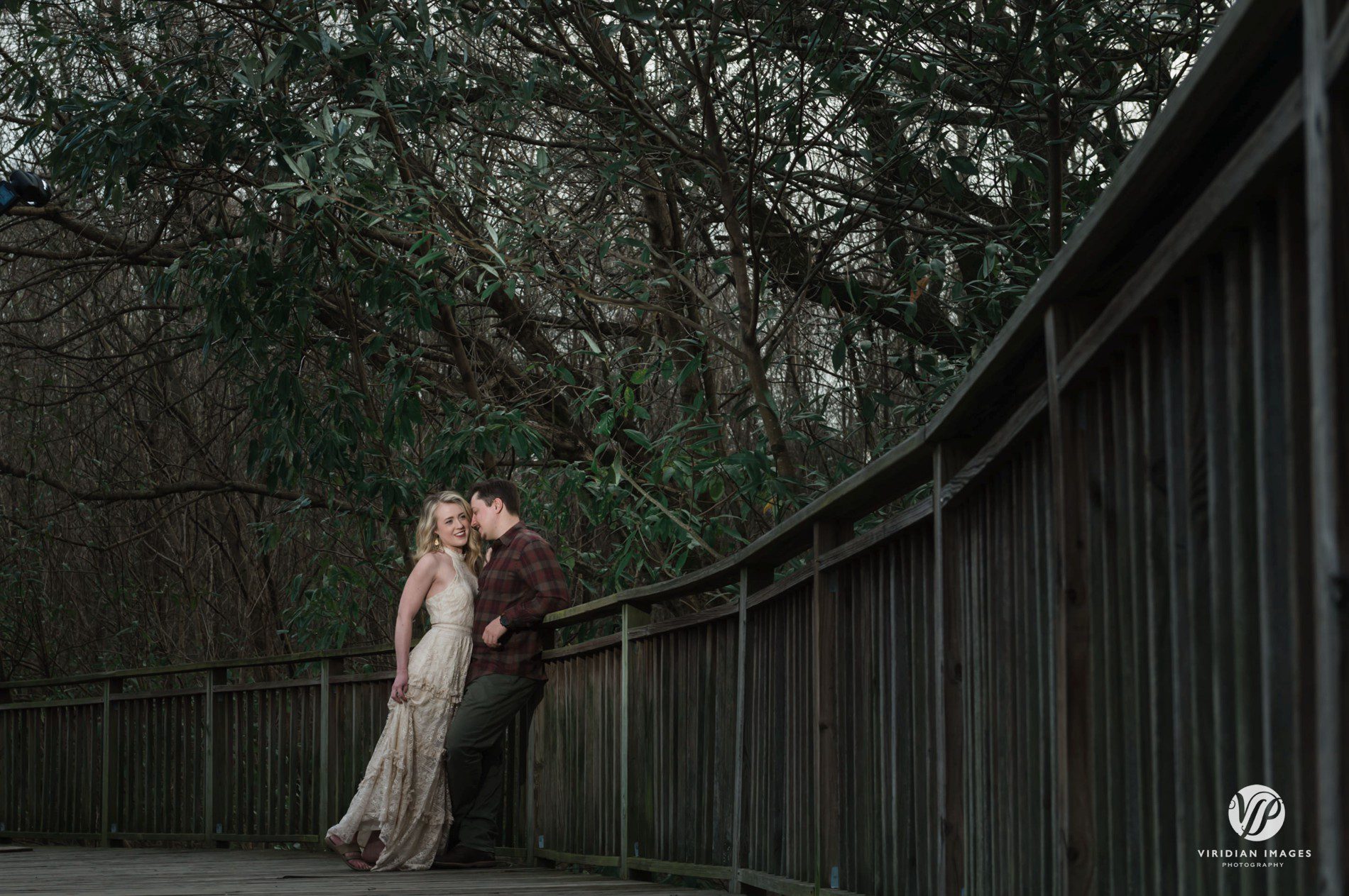 Winter engagement session at Piedmont Park walking along winding boardwalk